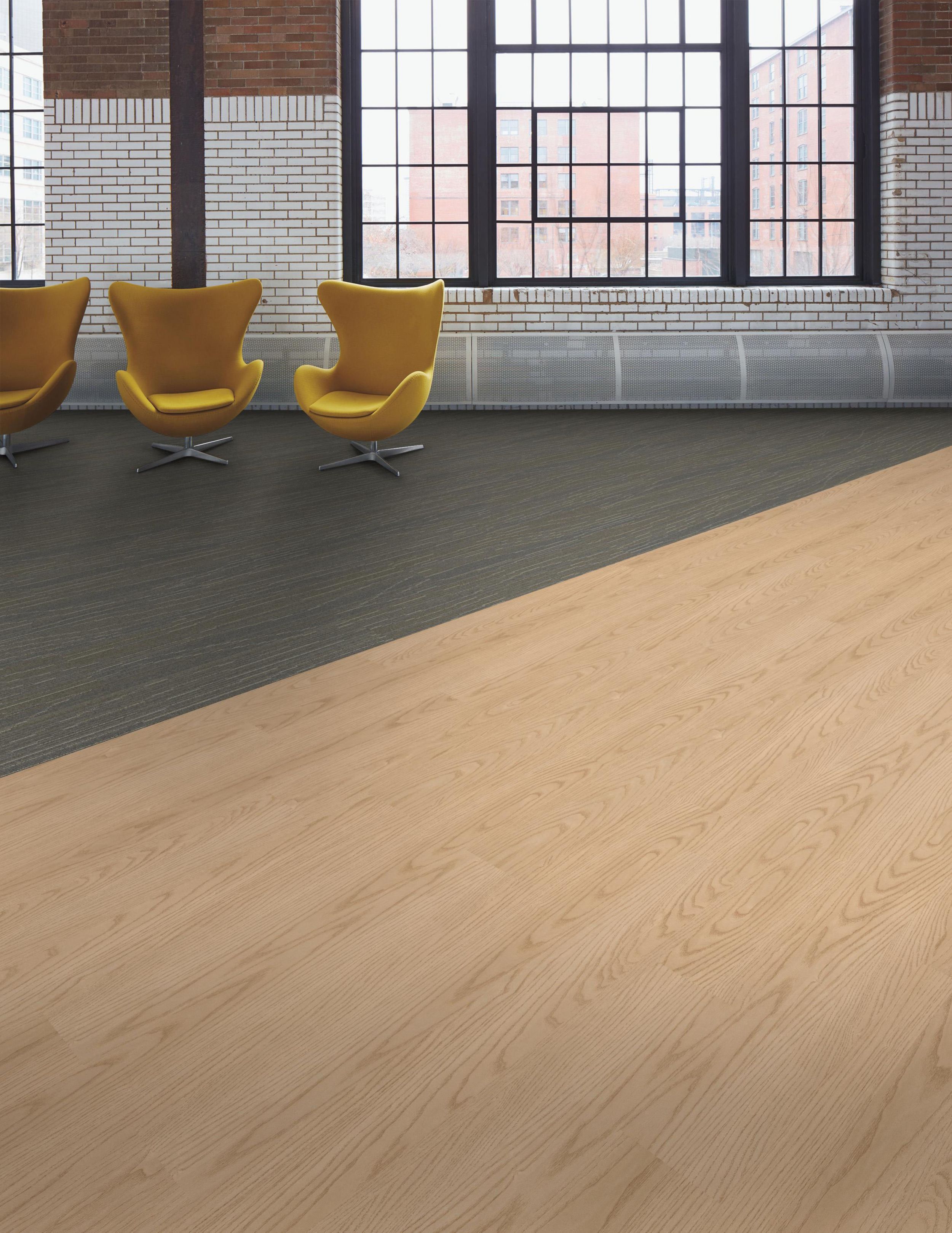 Interface Snow Moon plank carpet tile with Steady Stride Woodgrains LVT in open area with yellow chairs image number 3